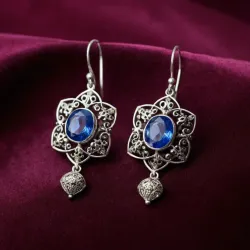 photo of #5 silver earrings with blue gem