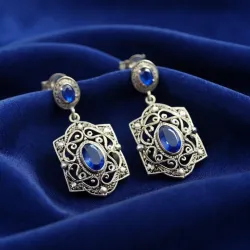 photo of #5 silver earrings with blue gem