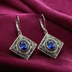 photo of #5 silver earrings with blue gem