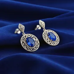 photo of #5 silver earrings with blue gem