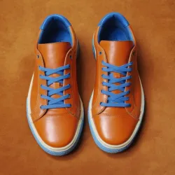 photo of #7 orange sneakers blue sole