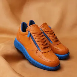 photo of #7 orange sneakers blue sole