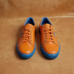 photo of #7 orange sneakers blue sole