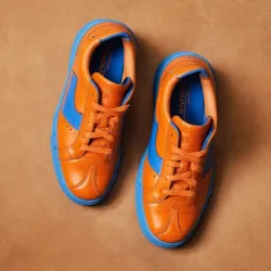 photo of #7 orange sneakers blue sole