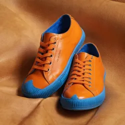 photo of #7 orange sneakers blue sole