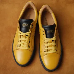 photo of #8 yellow sneakers black sole