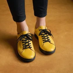 photo of #8 yellow sneakers black sole