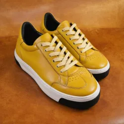 photo of #8 yellow sneakers black sole