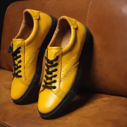 photo of #8 yellow sneakers black sole