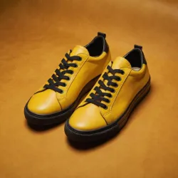 photo of #8 yellow sneakers black sole
