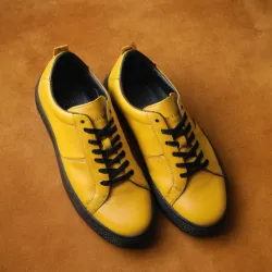 photo of #8 yellow sneakers black sole