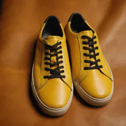 photo of #8 yellow sneakers black sole