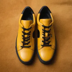 photo of #8 yellow sneakers black sole